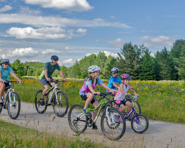 Family biking at Great Glen Trails two adults and three kids