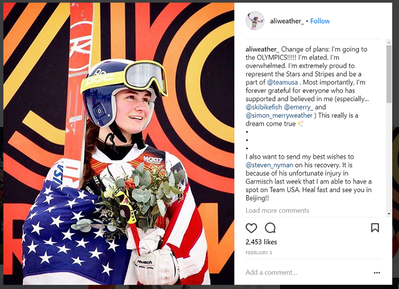 Alice wrapped in American flag holding Rossignol skis