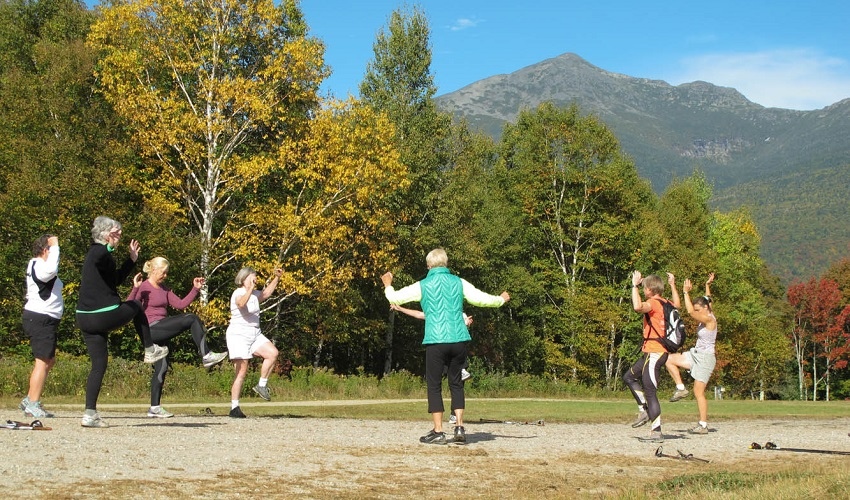 women balancing on one foot in a circle