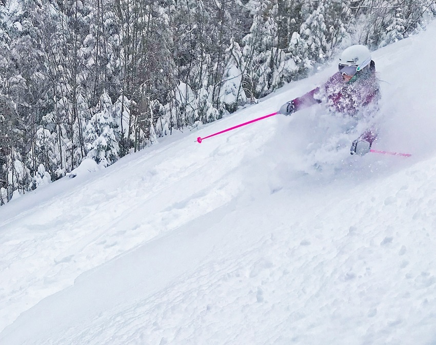 Skiing powder at Bretton Woods purple jacket pink poles
