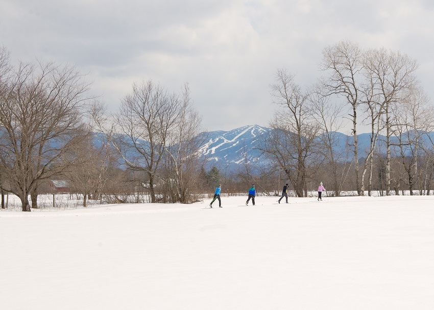 Cross country skiing at Hearth Farm with Sunapee in background