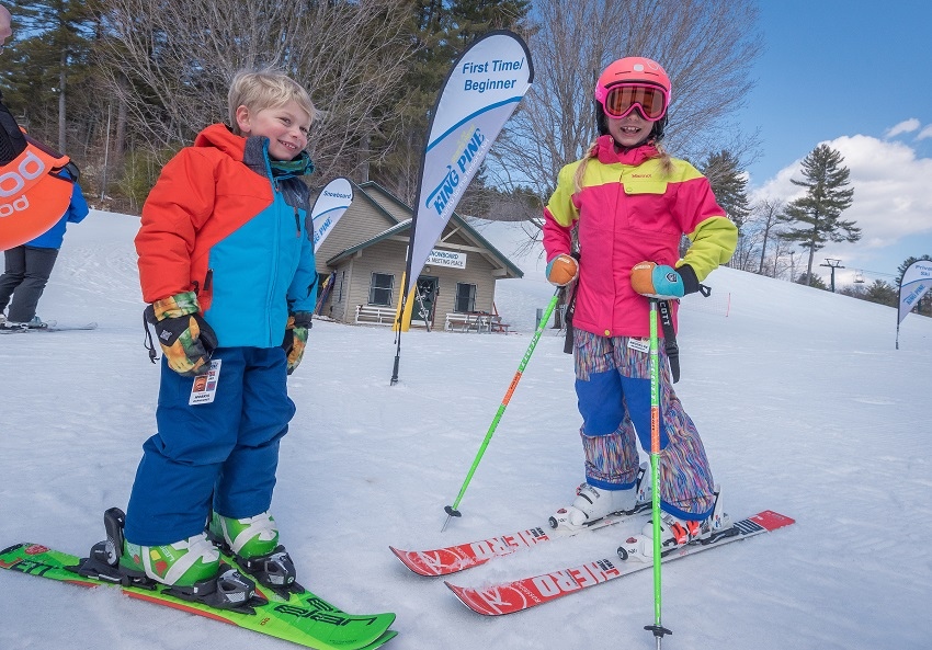 King Pine Ski School banner two children on skis