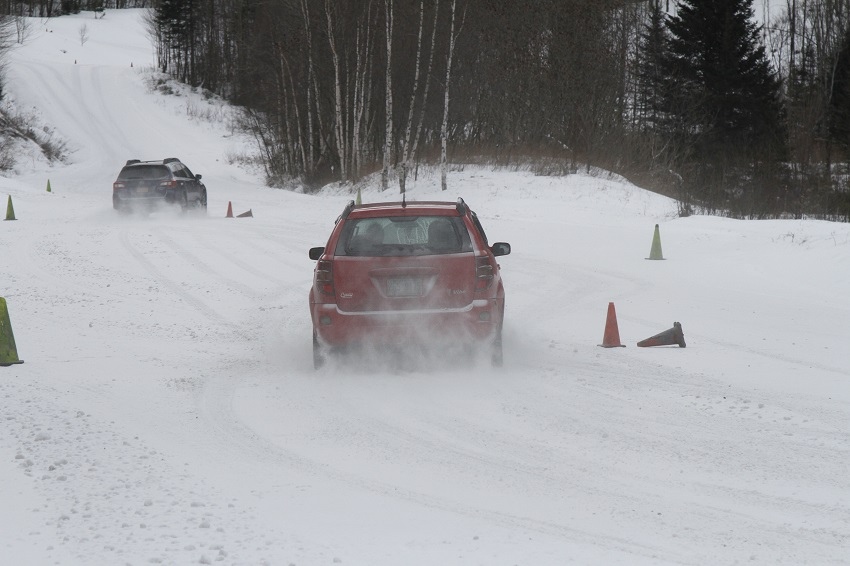Red Pontiac Vibe driving snow course