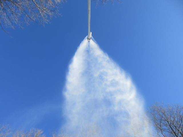 Snow gun looking up into blue sky