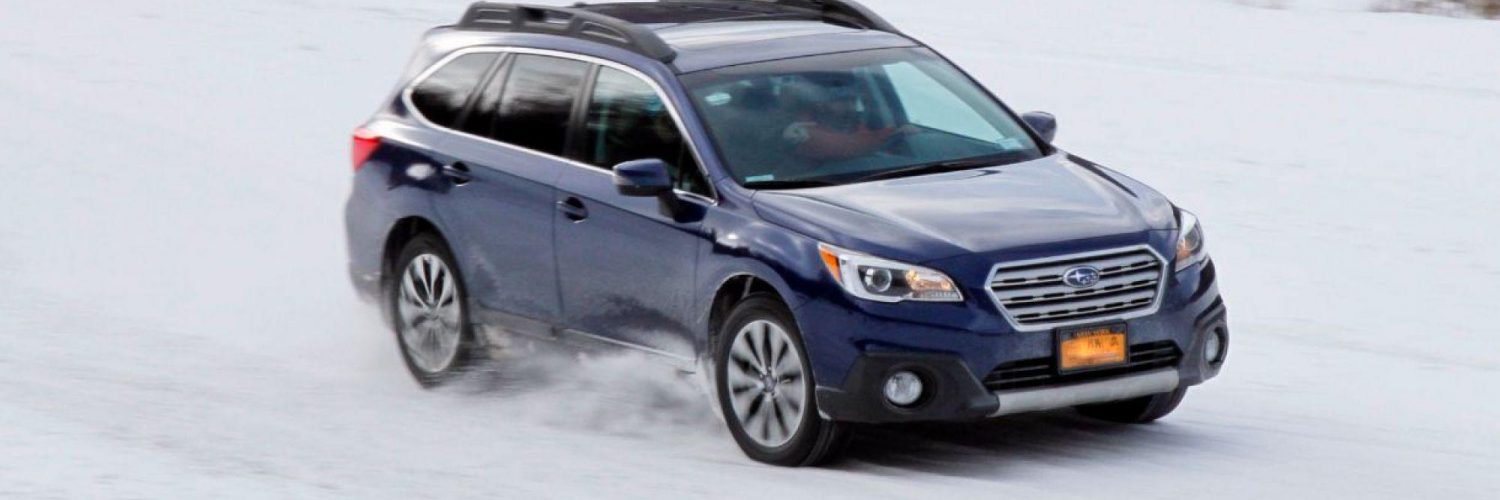 Subaru wagon driving in the snow