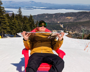 Cool kid in red adirondack chair soaking up the sunshine