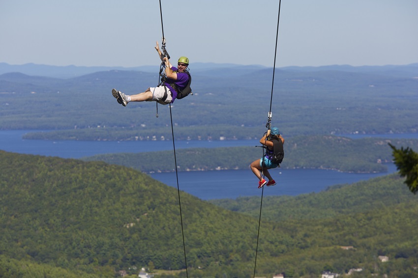 Two people ziplines