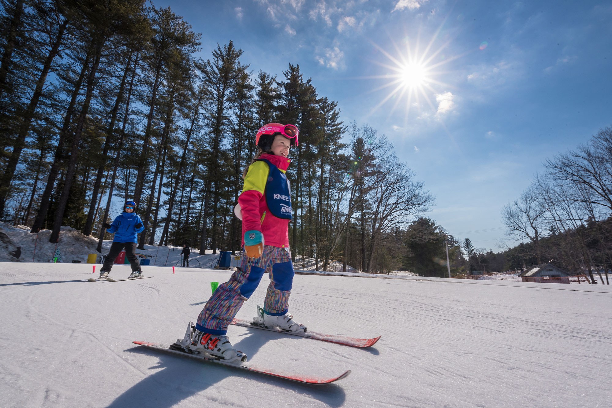 Girl on skis with King Pine vest