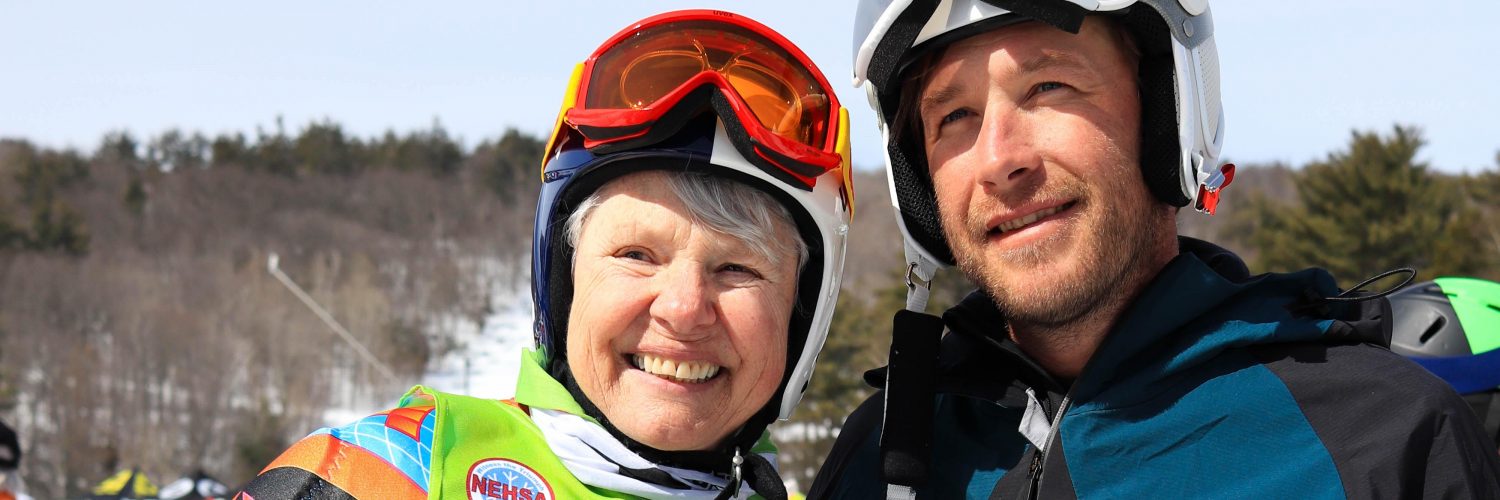 Senior Woman in Race Suit standing with Bode Miller
