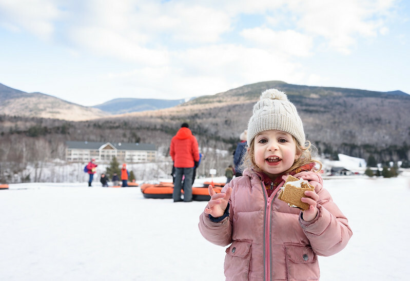 A little girl enjoys a s'more while on break from tubing